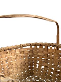 Wicker basket made of brown ash with bent handle