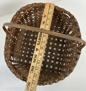 Wicker basket made of brown ash with bent handle