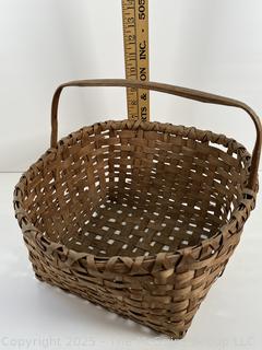 Wicker basket made of brown ash with bent handle