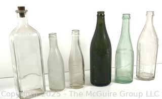 Group of six (6) antique glass bottles: various brands