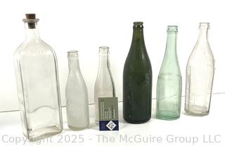 Group of six (6) antique glass bottles: various brands