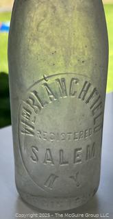 Group of six (6) antique glass bottles: various brands