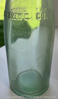 Group of six (6) antique glass bottles: various brands