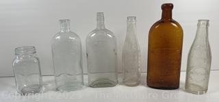 Group of six (6) antique glass bottles: various brands embossed