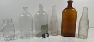 Group of six (6) antique glass bottles: various brands embossed