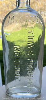 Group of six (6) antique glass bottles: various brands embossed