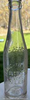 Group of six (6) antique glass bottles: various brands embossed