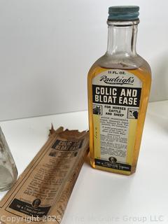 Group of antique glass bottles: various brands some with labels 