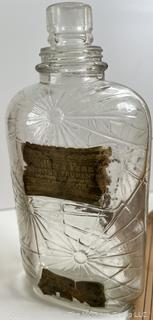 Group of antique glass bottles: various brands some with labels 