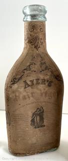 Group of antique glass bottles: various brands some with labels 