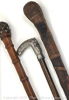 Three (3) ornate Victorian walking sticks/canes: hand-carved, metal pommels, designs