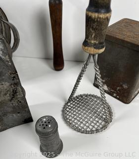 Assorted antique kitchen tools: colander, muffin tray, masher, tin, etc