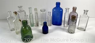 Selection of antique glass bottles mostly medicinal 