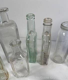 Selection of antique glass bottles mostly medicinal 