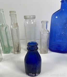 Selection of antique glass bottles mostly medicinal 
