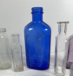 Selection of antique glass bottles mostly medicinal 