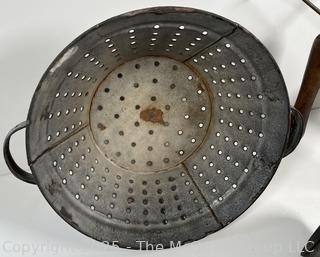 Assorted antique kitchen tools: colander, muffin tray, masher, tin, etc