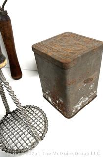 Assorted antique kitchen tools: colander, muffin tray, masher, tin, etc