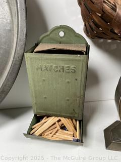????????  Eclectic grouping: metal tray; coffee tin; Hanging match holder; hack saw; alarm clock and wicker basket 