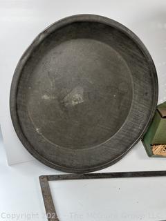 ????????  Eclectic grouping: metal tray; coffee tin; Hanging match holder; hack saw; alarm clock and wicker basket 