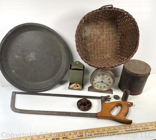 ????????  Eclectic grouping: metal tray; coffee tin; Hanging match holder; hack saw; alarm clock and wicker basket 