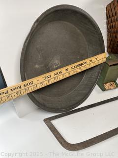 ????????  Eclectic grouping: metal tray; coffee tin; Hanging match holder; hack saw; alarm clock and wicker basket 