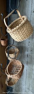 Hanging wrought iron hooked stand with wicker basket assortment 