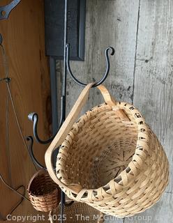Hanging wrought iron hooked stand with wicker basket assortment 
