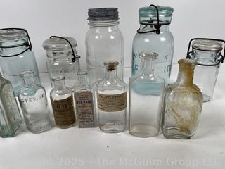 Large group of antique bottles and canning jars: various brands