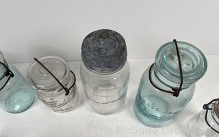 Large group of antique bottles and canning jars: various brands