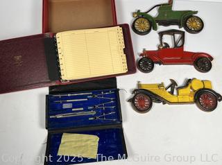 Three (3) Sexton Metal Car Wall Hangings Antique Cars; Drafting tools in storage case; and Vintage Ledger Book