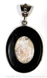Oval Onyx with Carved Mother of Pearl Set in Sterling Silver Pendant.  