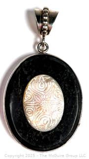 Oval Onyx with Carved Mother of Pearl Set in Sterling Silver Pendant.  