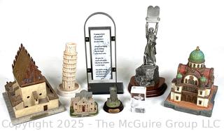 Collection of Travel Souvenirs Including Coin Banks and Figurines of Buildings