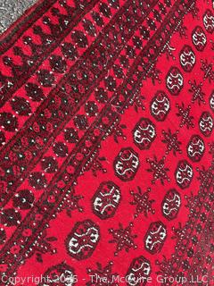Hand-knotted Afghan Akhche Wool Rug on Red Ground. 40" x 76"