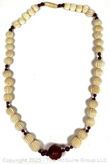 Graduated Carved Bone Bead Necklace with Carnelian Stone Center