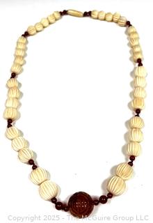 Graduated Carved Bone Bead Necklace with Carnelian Stone Center