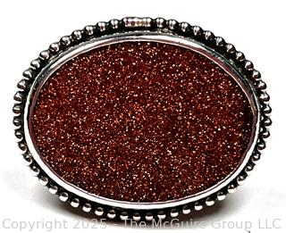 Sterling Silver Ring with Goldstone Center. 
