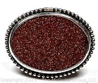 Sterling Silver Ring with Goldstone Center. 