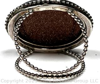 Sterling Silver Ring with Goldstone Center. 