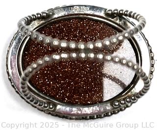 Sterling Silver Ring with Goldstone Center. 