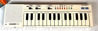 Radio Shack Armatron, Casio Pt-50 Electronic Piano Keyboard and Pressman Spelling Wheel