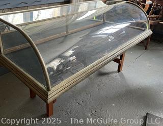 Curved Glass and Plexiglass  Countertop Display Cabinet w/ Two Fold Down Hinged Panels on Back. Missing one Panel of Glass as Shown in Photos 58"L<br>

<br><br>

Removal Options:<br><br> Sat (Nov 8) & Sun (Nov 9) 11-3pm, 56 Scotch Hill Rd., Cambridge NY 12816<br><br>


