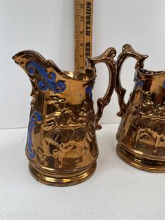 Two (2) Porcelain Lusterware Pitchers<br>

<br><br>

Removal Options:<br><br> Sat (Nov 8) & Sun (Nov 9) 11-3pm, 56 Scotch Hill Rd., Cambridge NY 12816<br><br>

Sat (Nov 15) 12-2pm, TMG Warehouse, 2800 Juniper St., Fairfax, VA 22031<br><br>

Request Shipping (david@themcguiregroupllc.com)
