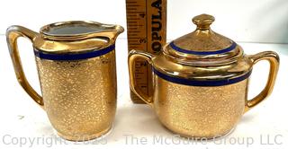 Porcelain Gold Creamer & Covered Sugar Bowl<br>

<br><br>

Removal Options:<br><br> Sat (Nov 8) & Sun (Nov 9) 11-3pm, 56 Scotch Hill Rd., Cambridge NY 12816<br><br>

Sat (Nov 15) 12-2pm, TMG Warehouse, 2800 Juniper St., Fairfax, VA 22031<br><br>

Request Shipping (david@themcguiregroupllc.com)