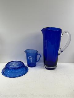 Cobalt Blue Glassware Including Hazel-Atlas Shirley Temple Plate and Mug and Bar Pitcher<br>

<br><br>

Removal Options:<br><br> Sat (Nov 8) & Sun (Nov 9) 11-3pm, 56 Scotch Hill Rd., Cambridge NY 12816<br><br>

Sat (Nov 15) 12-2pm, TMG Warehouse, 2800 Juniper St., Fairfax, VA 22031<br><br>

Request Shipping (david@themcguiregroupllc.com)