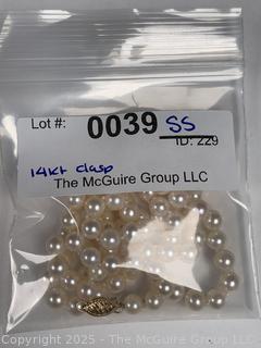 Knotted Pearl Necklace with 14kt Yellow Gold Clasp.  24"