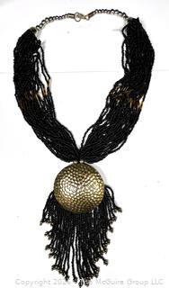 Multi Strand Black Seed Bead Necklace with Brass Tassel Pendant