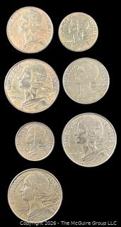 Seven (7) Foreign coins in plastic holders, various dates and denominations. France