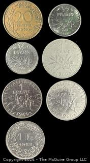 Seven (7) Foreign coins in plastic holders, various dates and denominations. France